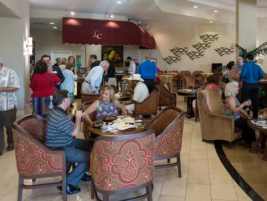 Residents and staff interacting in a lively common area