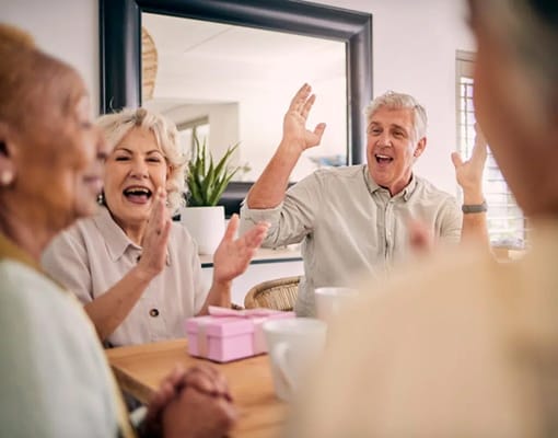 Residents enjoying a lively conversation at a table