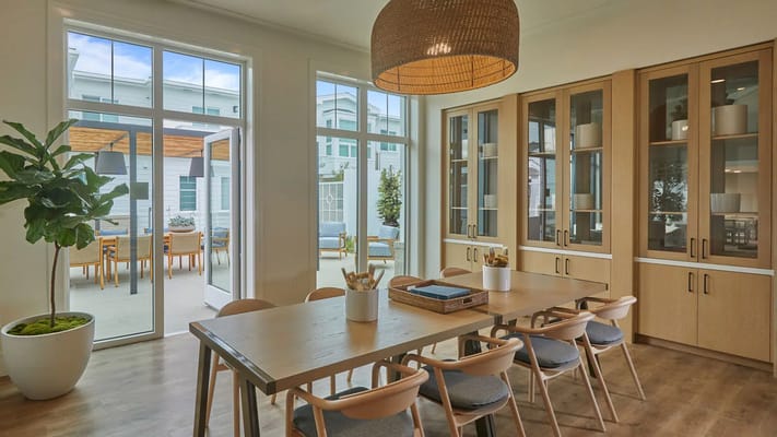 Bright common area with large windows and wooden decor