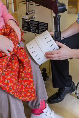 Therapist assisting a resident with a treatment device