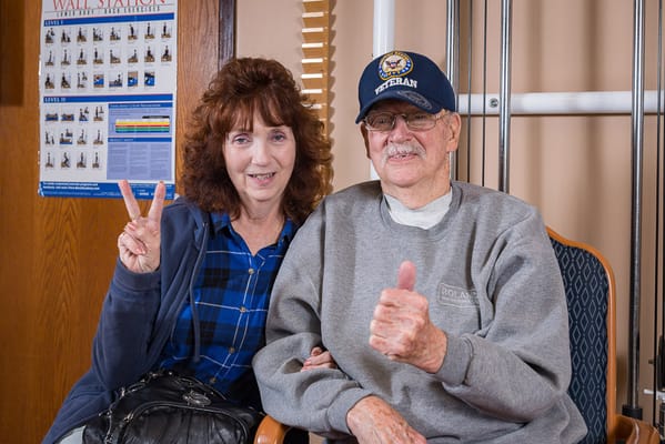 A smiling resident and visitor in the facility