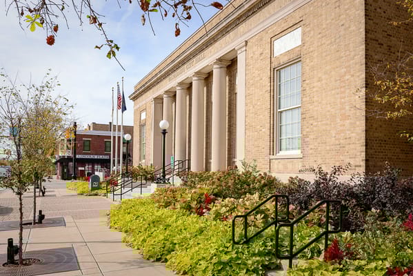 Exterior view of a building with landscaping and flags