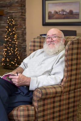 A resident enjoying a moment in a cozy armchair