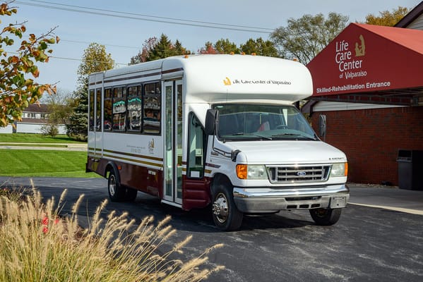 Facility transport van parked outside the entrance
