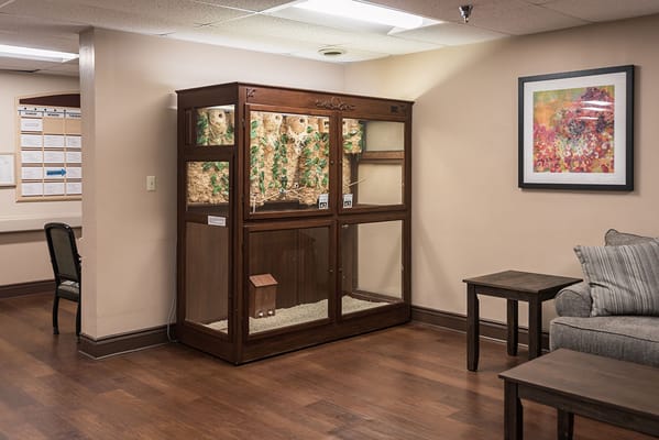 Common area with a pet enclosure and seating