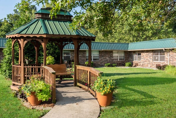 Outdoor gazebo with a walkway and flower pots