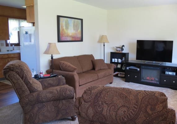 A cozy interior living room with seating and a TV