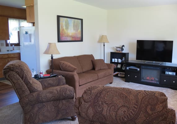 A cozy interior living room with seating and a TV