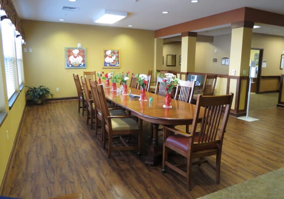 Dining room with a large table and floral decorations