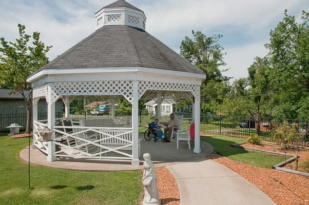 Residents enjoying time in a gazebo in the garden