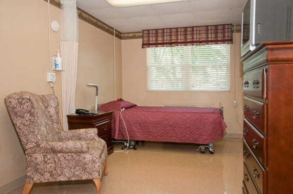 Cozy resident room with a bed and chair