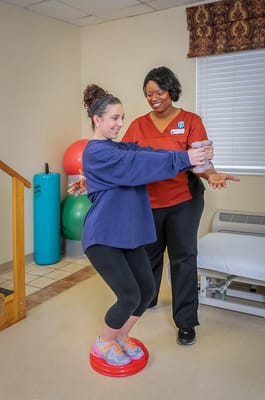 Therapist assisting resident with balance exercises