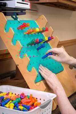 Hands engaging in an activity with colorful manipulatives