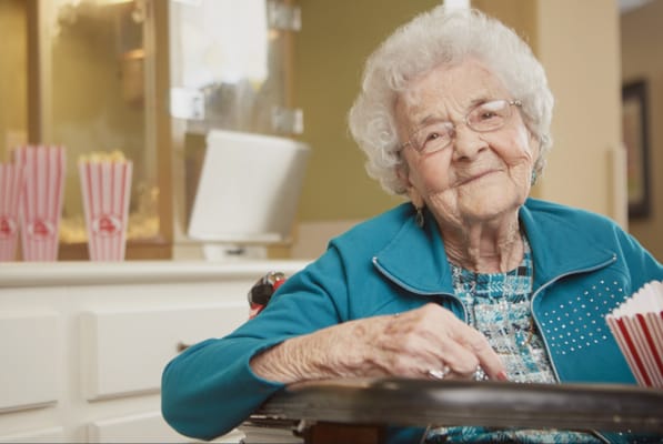 An elderly resident smiling while seated