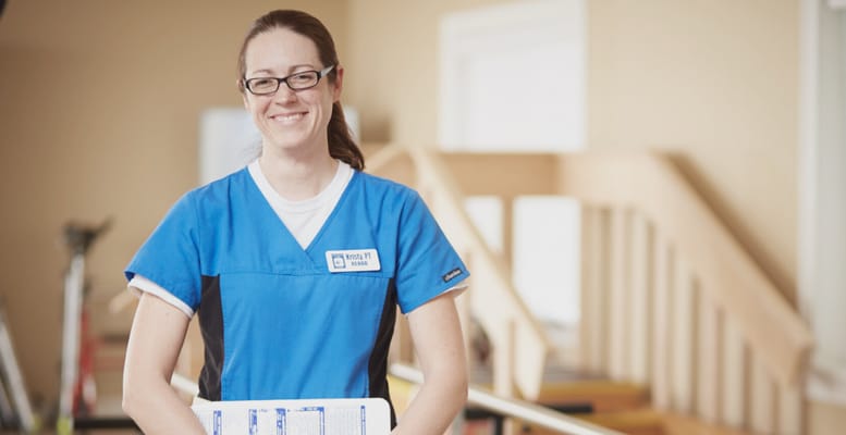 Healthcare worker smiling in a facility interior