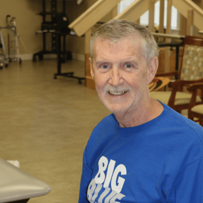 A smiling resident in an activity room