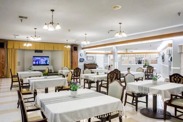 Bright dining area with tables and chairs set up