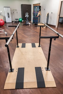Interior view of a rehabilitation therapy area with parallel bars
