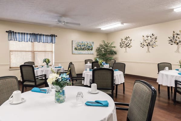 Dining area set up with tables for residents