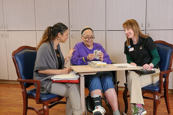 Two staff members interacting with a resident