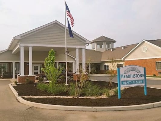 Exterior view of the Hearthstone Health Center with flag