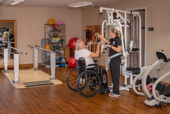 Therapy session with a resident in a gym setting