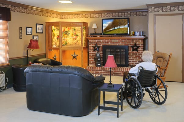 Resident in a wheelchair in a cozy living room