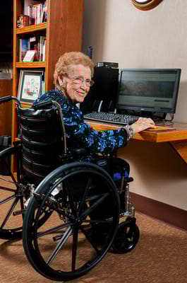 Resident using a computer in an office area