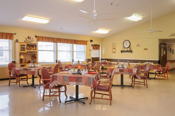 A bright dining room with tables set for meals