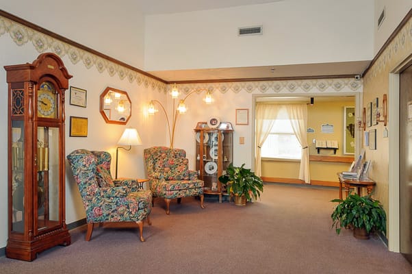 Common area with floral chairs and a lamp