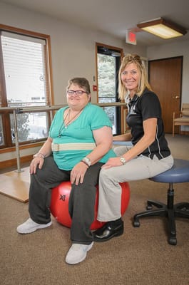 Therapist assisting resident during activity session