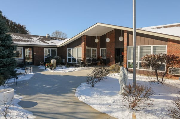 Exterior view of Life Care Center of Seneca with snowy pathway