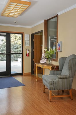 Interior view of a facility lobby with a chair and decor