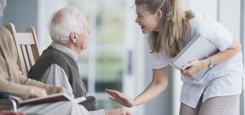 A caregiver interacting with a resident in a common area