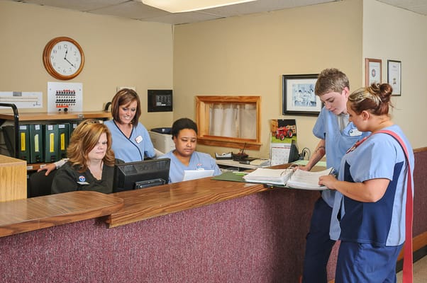 Staff assisting residents at the reception area