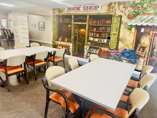Common area with a bookshop mural and seating