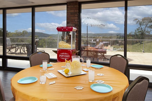 Common area with a decorated table and a popcorn machine