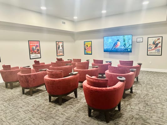 Interior view of a cozy sitting area with red chairs