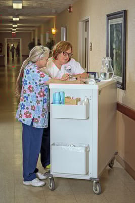 Staff assisting each other in a facility hallway