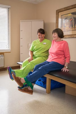 Staff member assisting a resident with therapy exercises