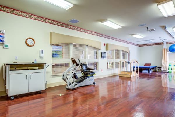 Interior room with exercise equipment and wooden floors