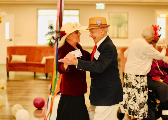 Residents enjoying a dance in a lively common area