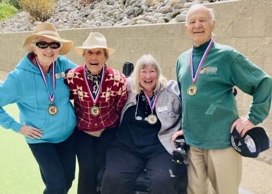Residents celebrating with medals outdoors