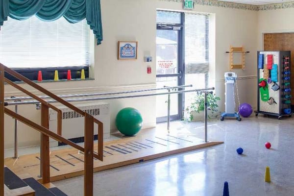 Rehabilitation activity room with equipment and various objects