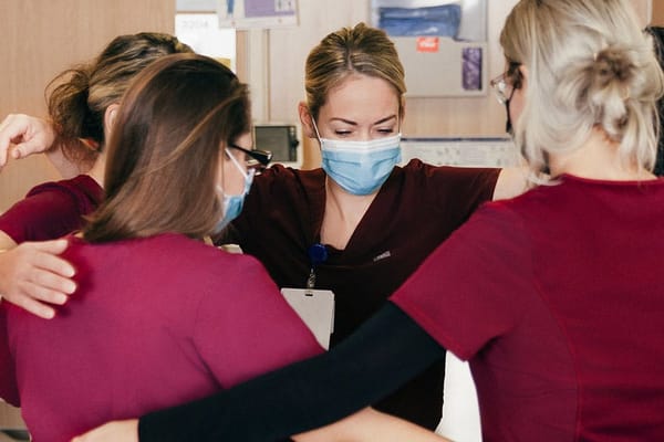 Staff members engaging in a team huddle