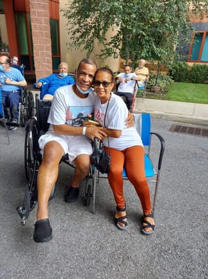 Two residents posing for a photo outdoors