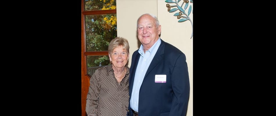 Two residents posing together in a cozy common area