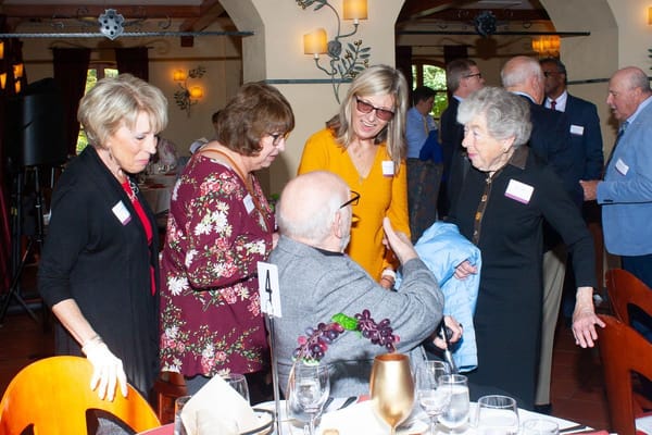 Residents and staff engaged in conversation at an event