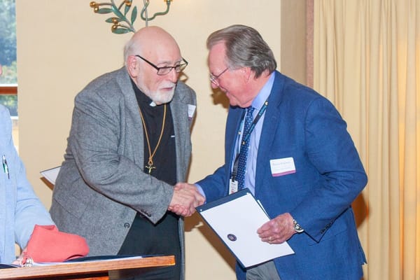Two men shaking hands during an event