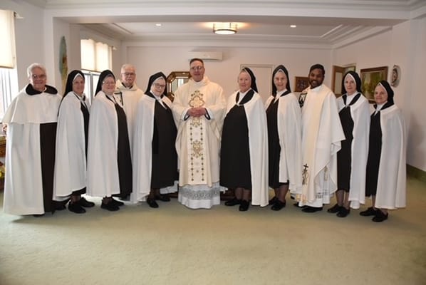 Group of individuals in formal attire inside a room